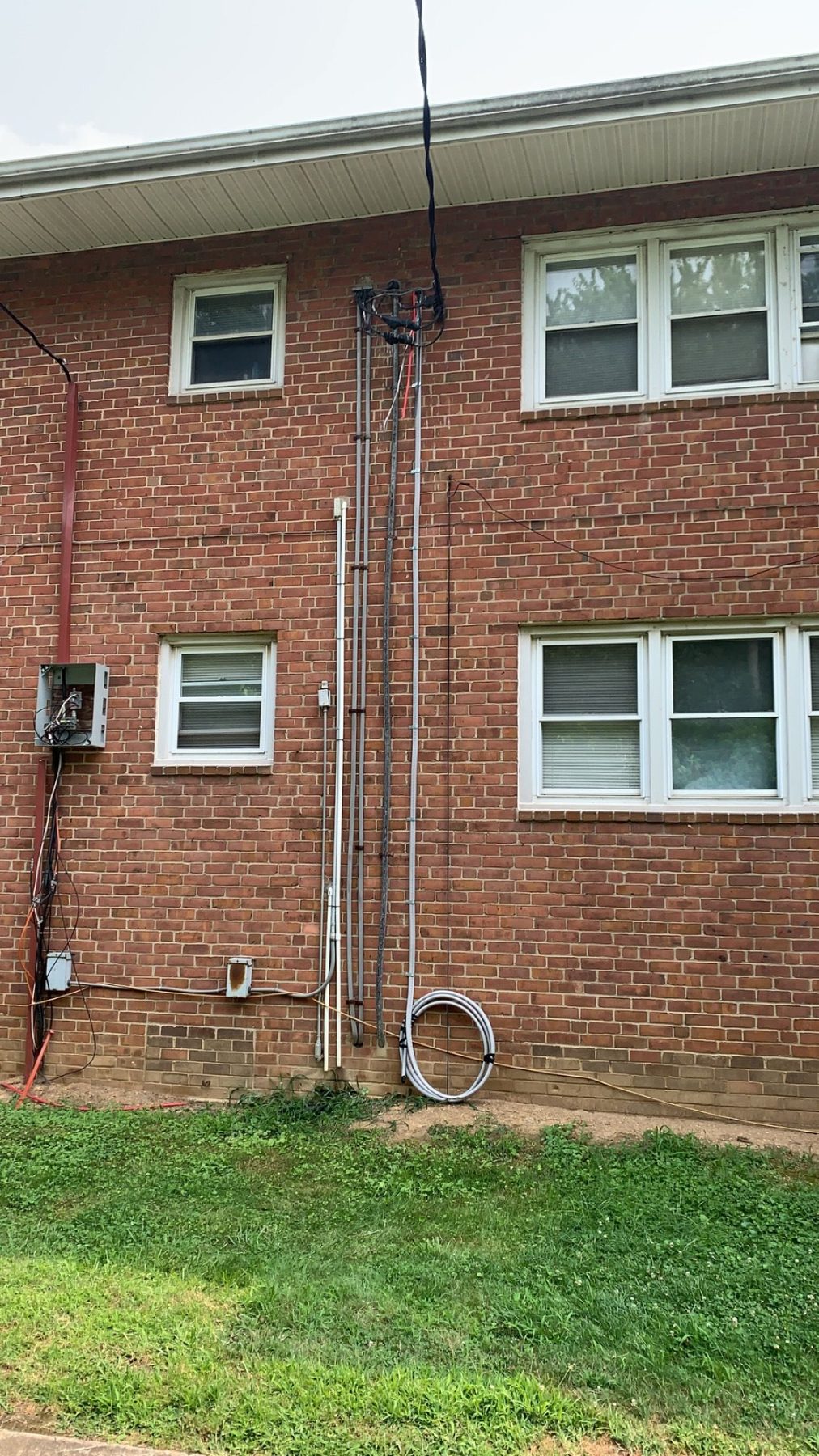 Exterior service wiring installed by CMD Electric on a brick building